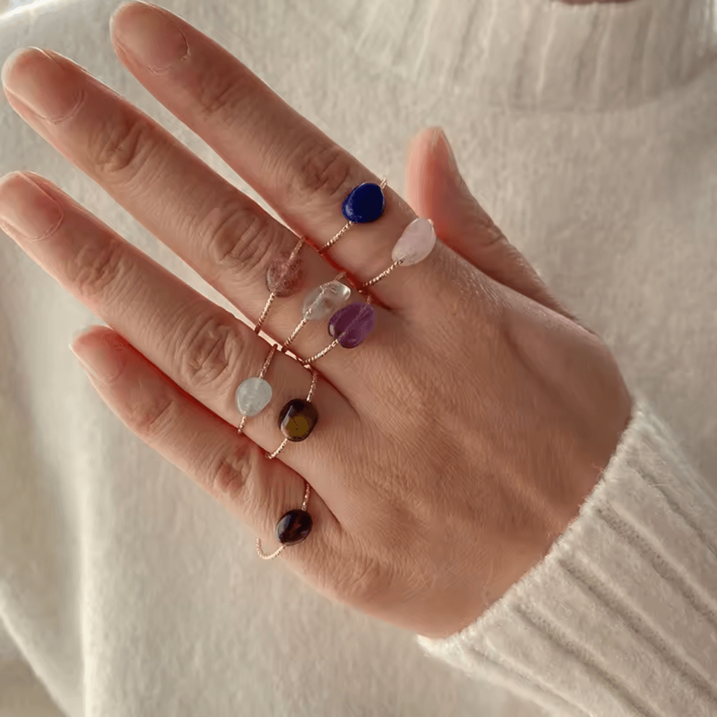 Raw amethyst and rose quartz crystal ring handcrafted on silver band showing rough unpolished gemstones